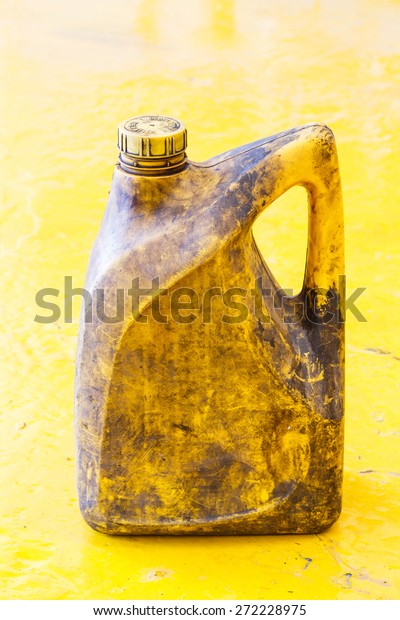 Close up old and dirty car\
engine oil gallon, plastic container, automotive maintenance\
service
