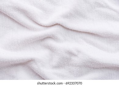 Close Up Of Old Dirty Wrinkled White Bedsheet Fabric Texture Background.