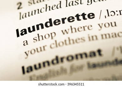 Close up of old English dictionary page with word launderette