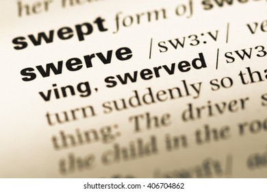 Close Up Of Old English Dictionary Page With Word Swerve