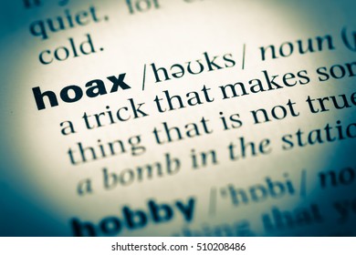 Close up of old English dictionary page with word hoax