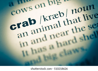 Close up of old English dictionary page with word crab