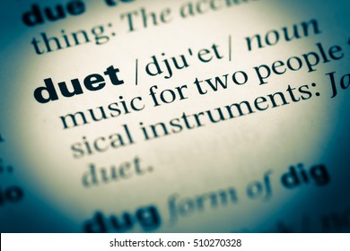 Close up of old English dictionary page with word duet - Shutterstock ID 510270328