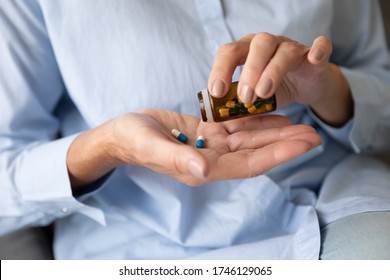 Close up old female hands holds glass bottle pours pills on palm taking daily dosage of medication, problem prevention, meds treat symptoms of Alzheimer, chronic senile diseases cure therapy concept - Shutterstock ID 1746129065