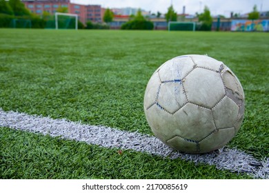 Close Up Of And Old Football At Football Field