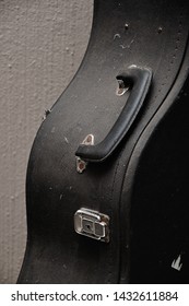 Close Up Of An Old Guitar Case Against A Wall