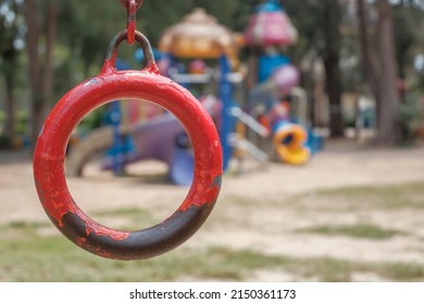Close up old hanging ring, monkey bar on blur kids park in the afternoon background.