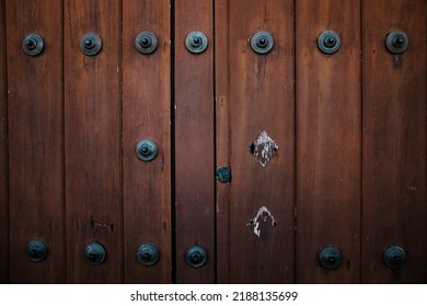 Close up of an old historic wooden door with metal studs
