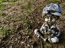 Close Up Of Old Lawn Statue Photo Of Creepy Little Boy Holding Dog On Dirt And Grass Background Texture