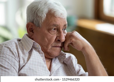 Close Up Old Male Put Head On Hand Lost In Sad Thoughts Memories, Widower Yearning For His Wife Feels Lonely In Nursing Home, 70s Senior Man Has Senile Disease Geriatric Medicine End Of Life Concept