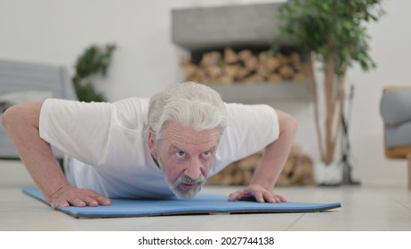 Close Up Of Old Man Doing Pushups On Excercise Mat At Home