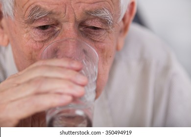 Close Up Of Old Man Drinking Water From Glass