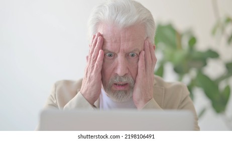 Close Up Of Old Man Reacting To Loss While Using Laptop