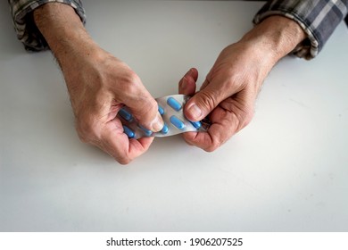 Close up of old man taking antibiotic and pills at home. Daily norm of vitamins, effective drugs, modern pharmacy for body and mental health concept. Mature man taking a pill while sitting on the bed. - Powered by Shutterstock