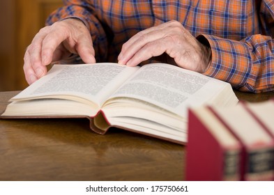 Close up of old man's hands who's reading book - Shutterstock ID 175750661