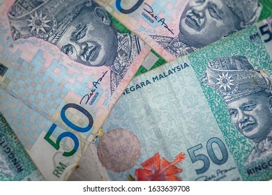 A close up to the old and the new banknote of 50 Ringgit Malaysia. A bunch of fifty ringgit notes, the currency of Malaysia.