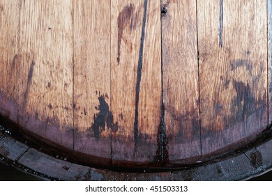 Close Up Of Old Oak Wine Barrel With Wine Drips, Leak Traces. Contents Are Leaking Down The Side Of Barrel. 