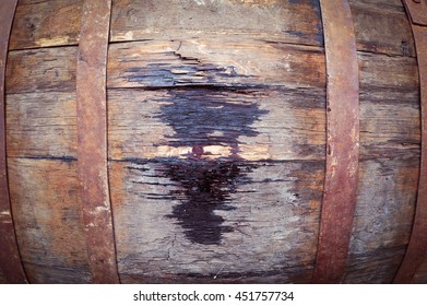 Close Up Of Old Oak Wine Barrel With Wine Drips, Leak Traces. Contents Are Leaking Down The Side Of Barrel. 