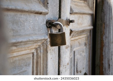 Close up of old padlock on the aged, rotten, abandoned wooden gate. Rusty, Aged, Wooden gate, Door, Old padlock - Powered by Shutterstock