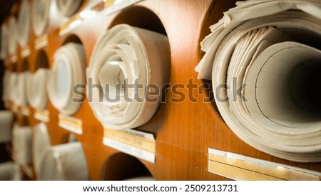 Close up of Old paper map rolled document file archive blueprint storage hardcopy conventional
