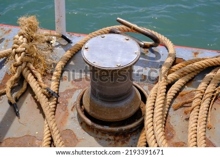 Close up of Old ropes and rusty bollard. rope and Marina bollard on moorage. The concept of mooring and water transportation
