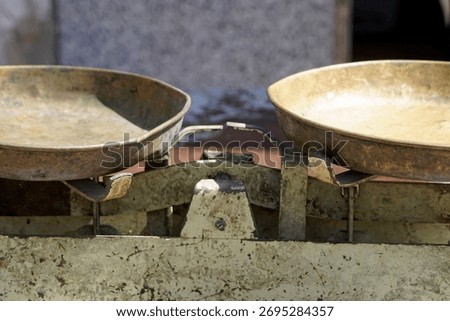 Close up of old run down two pan balance scale