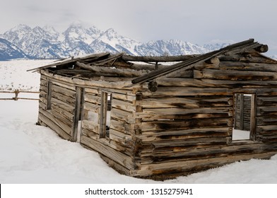 Close up of the old Shane Cabin from the classic film with the Teton Range mountains in Wyoming in winter