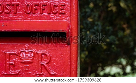 Close up of an old square style red post box in UK