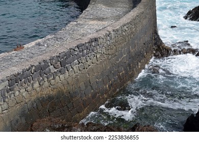 Close Up of Old Stone Harbour Wall and Breaking Waves  - Shutterstock ID 2253836855