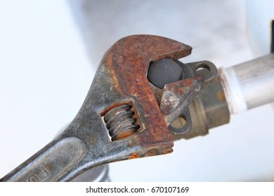 Close Up Of Old Universal Adjustable Wrench Adjusting Water Meter. Closeup Bench Tool. Selected Focus