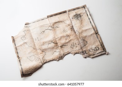 Close up to old vintage map with fake island of Pirates treasure