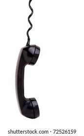 Close Up Of An Old Vintage Phone Handset Hanging By The Chord Isolated Over A White Background.