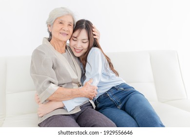 Close Up Old Woman, Young Asian Female Hug Old Female In Home, They Feeling Happy And Smile, They Sitting On Sofa, Mother's Day, Happiness Elderly In Family Time