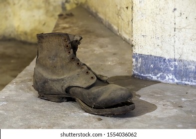 Close up of an old worn out shoe, on the ground in a German air-raid shelter. Original remnant of 1944, after the Allied bombing of German cities.