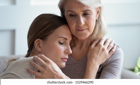 Close Up Older 60s Mother Comforting Sad Adult Daughter Closed Eyes Snuggles To Mom Looking For Support Share Problems Personal Troubles, Understanding Of Two Age Generations Relative Females Concept