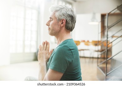 Close Up Older Man Meditating Indoors