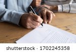 Close up older man putting signature on legal documents, mature couple, wife and husband making purchasing or investment deal, taking loan or buying new house, senior male signing contract