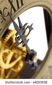 Close up of old-fashioned wall clock with visible gears, isolated on white background. Intentional shallow depth of field. Studio work.