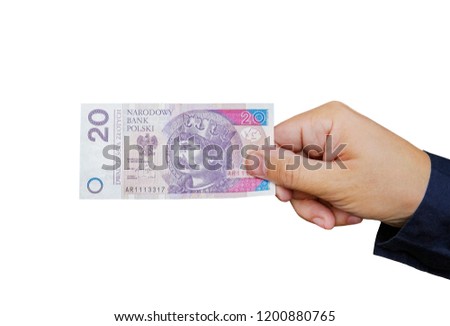 Close up on a 20 zloty banknote in a man's hand. Isolated object on white background.