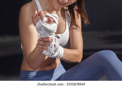 Close Up On Asian Female Boxer Grab Her Wrist With Pain From Her Wrist Injury