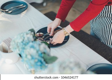 Close Up On Asian Woman Hands, That Setting Up The Table For Dinner In Urban Elegance Restaurant.