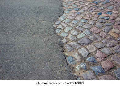 Close up on a asphalt and cobbled road in Natolewice, small village located in West Pomerania region of Poland