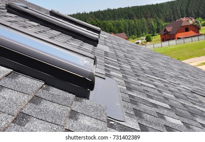 Close Up On Attic Skylight Window Repair With Waterproofing Membrane On Asphalt Shingles Roof. Roofing Construction.