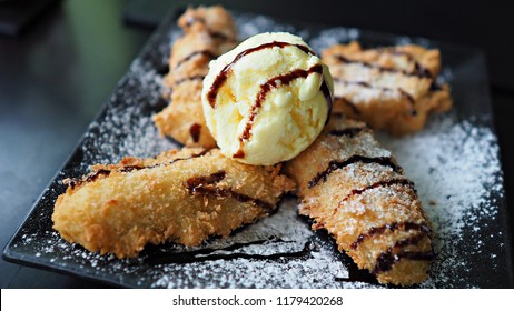 Close Up On Banana Fritter With Vanilla Ice Cream On Top.  Popular Dessert Menu In Vietnamese Restaurant.