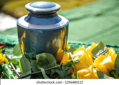 Close Up On A Burial Urn With Yellow Roses, In A Bright Cemetery Scene, With Space For Text On The Right