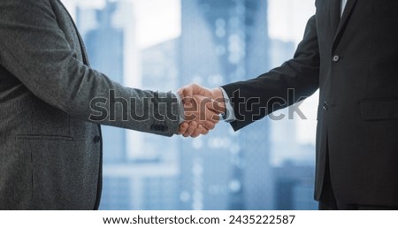 Close Up on Business Partners Sahking Hands After Agreeing On Profitable Deal in Office Meeting Room. Corporate CEO and Investment Manager Handshake on a Lucrative Financial Opportunity.
