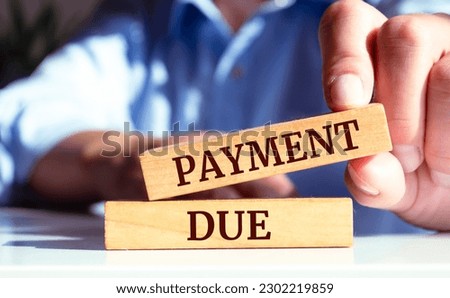 Close up on businessman holding a wooden block with a 