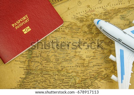 Close up on Canada map with passport and toy aircraft. Travel concept. Canada is a country in the northern part of North America.