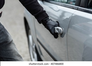 Close Up On Car Thief Hand Pulling The Handle Of A Car. Car Thief, Car Theft Concept