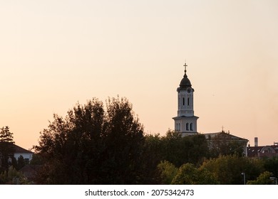 Close up on Church clocktower steeple of the serbian orthodox church of Crkva svetog duha, church of the holy spirit, during a sunny sunset in Obrenovac, Serbia with its iconic clock indicating time - Shutterstock ID 2075342473